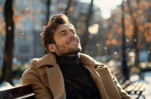 Man Wearing a Brown Coat Sitting on a Bench in the Sunlight photo