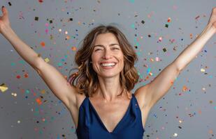 Woman Celebrates With Confetti and Raised Arms photo