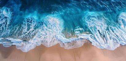 Aerial View of Turquoise Water Breaking on Sandy Beach photo