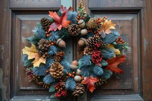 Autumnal Wreath With Pine Cones and Maple Leaves on Wooden Door photo
