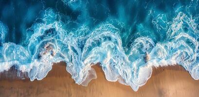 Aerial View of Turquoise Water Breaking on Sandy Beach photo