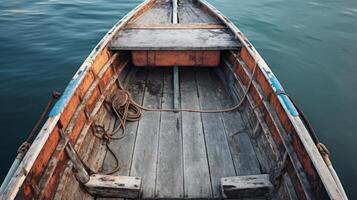 An old wooden rowboat sits on tranquil waters, ready for its next adventure photo