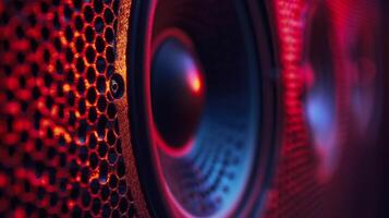Close-up shot of a speaker cone illuminated in red photo
