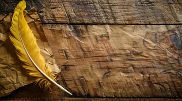 A single golden quill rests on aged wood with crumpled paper beside it photo