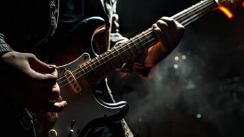 A musician plays a guitar on stage in front of a crowd photo