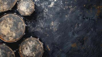 Four drumheads on a black textured background photo