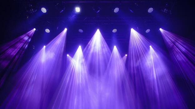 Stage lights shine brightly, illuminating a dark performance space photo