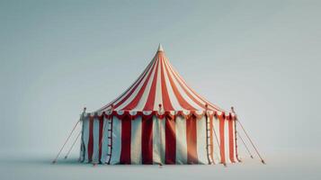 A single, iconic circus tent stands alone against a pale blue sky photo