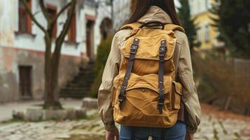 Backpacker wanders cobblestone streets in old European city photo
