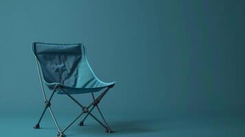 A teal folding chair stands ready for outdoor relaxation photo