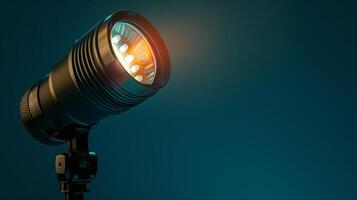 A close-up shot of a black spotlight on a teal backdrop photo