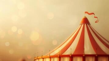 A classic circus tent stands tall against a backdrop of golden sunset light photo