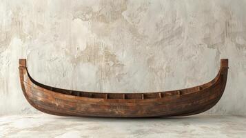 A wooden rowboat sits empty against a textured concrete wall photo