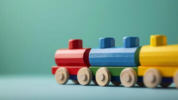 A close-up of a colorful wooden train toy on a turquoise background photo