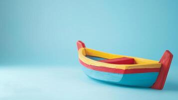 A brightly colored wooden boat toy sits on a light blue background photo