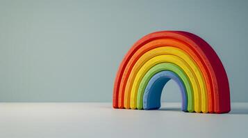 A rainbow toy made of wood with various colors photo