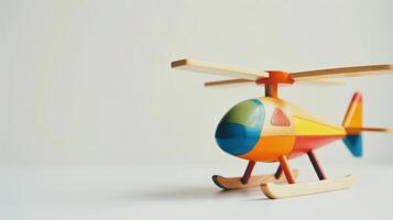 Colorful wooden helicopter toy on a white background photo