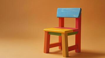 A colorful wooden toy chair sits alone on a tan background photo