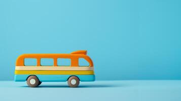 A colorful wooden school bus toy sits on a blue background photo