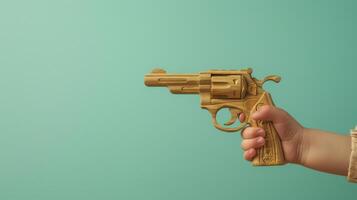 A close-up shot of a childs hand holding a wooden toy gun photo