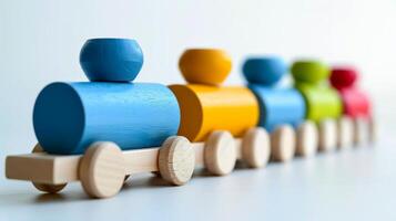 A colorful wooden train toy with various colored cars photo