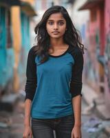 A young woman wearing a blue raglan shirt walks confidently through a colorful alleyway photo