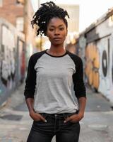 A woman in a raglan shirt stands in an alleyway photo