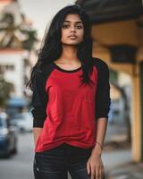 A woman wears a red and black raglan shirt photo
