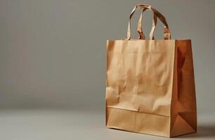 Brown Paper Shopping Bag With Rope Handles on Grey Background photo
