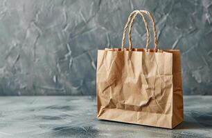 Brown Paper Shopping Bag With Rope Handles on Grey Background photo