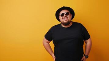 A man in a black t-shirt and hat smiles for the camera photo