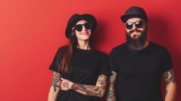 A young couple poses with happy expressions, wearing black t-shirts and sunglasses photo