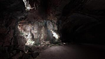 A cave with a light at the end of it video