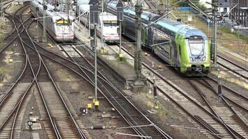 View of moving and stationary trains on railway tracks at a station in northern Germany. video