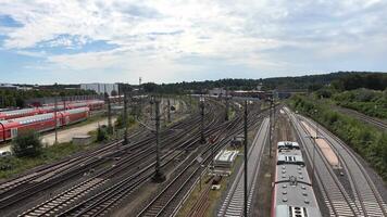 View of moving and stationary trains on railway tracks at a station in northern Germany. video