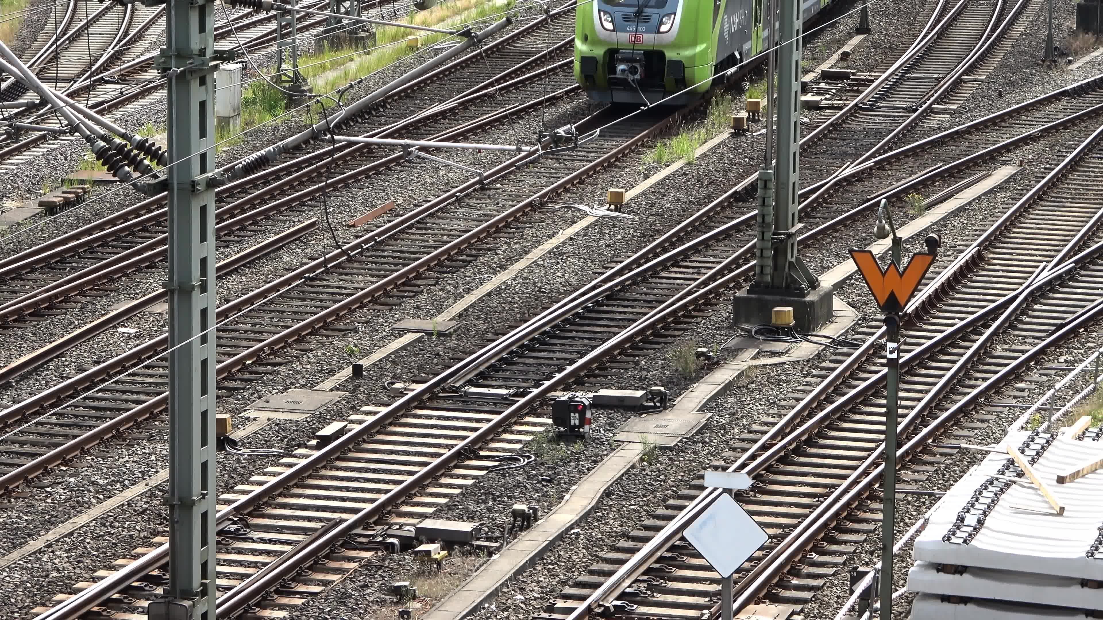 View of moving and stationary trains on railway tracks at a station in ...