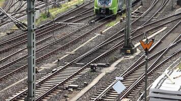 View of moving and stationary trains on railway tracks at a station in northern Germany. video