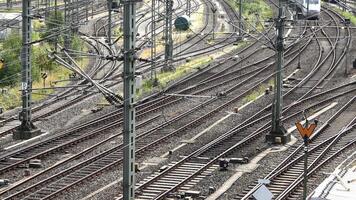 View of moving and stationary trains on railway tracks at a station in northern Germany. video