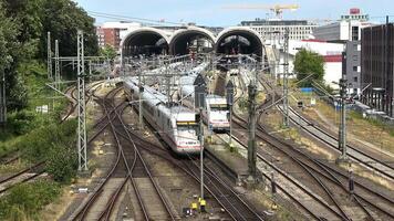 View of moving and stationary trains on railway tracks at a station in northern Germany. video