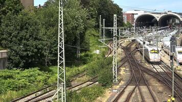 View of moving and stationary trains on railway tracks at a station in northern Germany. video
