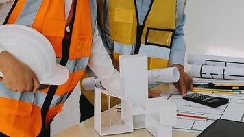 Construction and structure concept of engineer working drawing on blueprint meeting for project working with partner on model building and engineering tools in working site, construction concept video