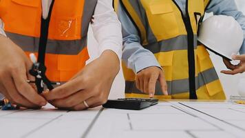 Construction and structure concept of engineer working drawing on blueprint meeting for project working with partner on model building and engineering tools in working site, construction concept video