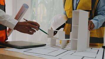 Construction and structure concept of engineer working drawing on blueprint meeting for project working with partner on model building and engineering tools in working site, construction concept video