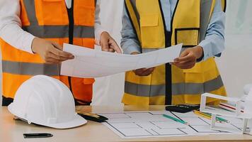 Construction and structure concept of engineer working drawing on blueprint meeting for project working with partner on model building and engineering tools in working site, construction concept video