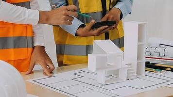 Construction and structure concept of engineer working drawing on blueprint meeting for project working with partner on model building and engineering tools in working site, construction concept video