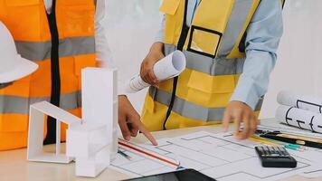 Construction and structure concept of engineer working drawing on blueprint meeting for project working with partner on model building and engineering tools in working site, construction concept video
