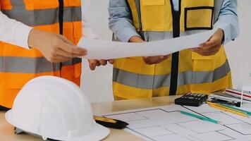 Construction and structure concept of engineer working drawing on blueprint meeting for project working with partner on model building and engineering tools in working site, construction concept video