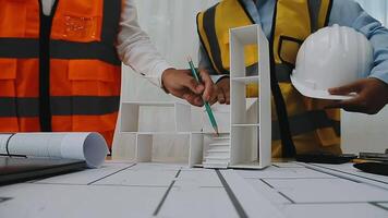 Construction and structure concept of engineer working drawing on blueprint meeting for project working with partner on model building and engineering tools in working site, construction concept video