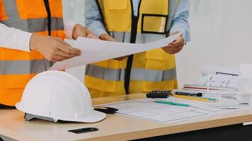 Construction and structure concept of engineer working drawing on blueprint meeting for project working with partner on model building and engineering tools in working site, construction concept video