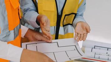 Construction and structure concept of engineer working drawing on blueprint meeting for project working with partner on model building and engineering tools in working site, construction concept video